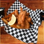 Shrimp Basket - A serving basket of six large plump shrimp lightly fried in panko served with English “chips” and cocktail sauce.