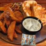 Grilled Cheese Sandwich & Fries - Kids grilled cheese sandwich served with crispy golden-brown wedge fries, ranch dipping sauce and a delightful snack.