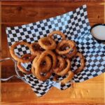 Onion Rings - Crispy deep fried onion rings with ranch dressing on the side.