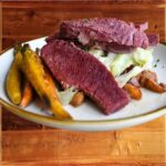 Reuben Sandwich - Barrington's Reuben Sandwich — Corned beef, Swiss and Dubliner cheddar cheese with sauerkraut on marbled rye served with English “chips” and Russian dressing on the side.