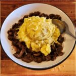 Mushroom Cottage Pie - A bowl of Barrington's Mushroom Cottage Pie filled with mushrooms, peas, carrots, and green beans in a rich Guinness and red wine gravy topped with mashed potatoes.