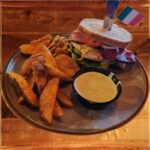 Chicken Club Sandwich - Barrington's Chicken Club Sandwich — Grilled chicken on toasted sourdough with lettuce, tomato, onion, rasher, Dubliner cheddar, and pickle served with English “chips” and ranch dressing on the side.
