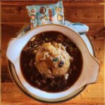 Shepherd’s Pie - A bowl of Barrington's Shepherd’s Pie filled with a savory blend of lamb and beef, slow-cooked with, carrots, peas, and green beans in a rich Guinness and red wine gravy topped with colcannon mashed potatoes and served with a delightful snack.