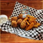Chicken Nuggets & Fries - Crispy, golden bite-sized fried chicken served with wedge fries and a tasty snack.